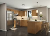 Thumbnail 11 of 11 - A modern kitchen with wooden cabinets and stools.