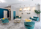 Thumbnail 15 of 23 - Lobby with blue chairs and yellow and green furniture at 500 Fifth Apartments, Nashville, Tennessee