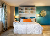 Thumbnail 20 of 23 - Bedroom with a bed and a blue wall and a window at 500 Fifth Apartments, Nashville