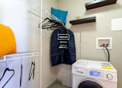 Thumbnail 23 of 23 - Laundry room with a washing machine and a jacket on a rack at 500 Fifth Apartments, Nashville, 37219