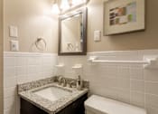 Thumbnail 22 of 23 - Bathroom with a sink and a mirror and a toilet at 500 Fifth Apartments, Nashville, TN, 37219