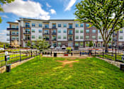Thumbnail 47 of 47 - Exterior view of building and grass at The Monroe Apartments, Austin, Texas