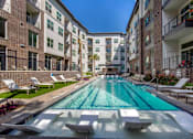 Thumbnail 20 of 47 - Outdoor pool with Apartment Building View at The Monroe Apartments, Austin, TX, 78741