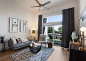 Thumbnail 2 of 47 - Open living room with a sliding glass door to a balcony at The Monroe Apartments, Austin, 78741