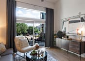 Thumbnail 4 of 47 - Living room with a sliding glass door to a patio at The Monroe Apartments, Austin, TX, 78741
