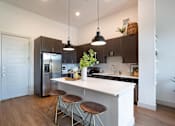 Thumbnail 6 of 47 - Kitchen with a large island at The Monroe Apartments, Texas, 78741