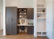 Thumbnail 10 of 47 - a home office with a desk and a refrigerator at The Monroe Apartments, Austin