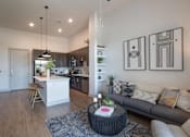 Thumbnail 5 of 47 - a living room with a couch and a table at The Monroe Apartments, Austin