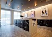 Thumbnail 40 of 47 - a view of the lobby of a building with many lockers at The Monroe Apartments, Austin, TX