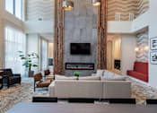 Thumbnail 30 of 47 - a living room with couches and chairs and a fireplace at The Monroe Apartments, Texas, 78741
