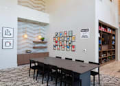 Thumbnail 35 of 47 - a conference room with a long table and chairs and a bulletin board on the wall at The Monroe Apartments, Texas, 78741
