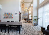 Thumbnail 36 of 47 - a conference room with a large table and chairs and a large window at The Monroe Apartments, Austin, Texas