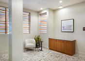 Thumbnail 38 of 47 - an office with a chair and a desk and windows at The Monroe Apartments, Austin, TX, 78741