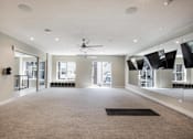 Thumbnail 46 of 47 - a large living room with a ceiling fan and a carpet at The Monroe Apartments, Texas, 78741