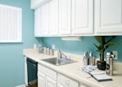 Thumbnail 12 of 14 - White cabinet kitchen at Emory Woods Apartments, Durham, NC.