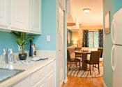 Thumbnail 5 of 14 - White kitchen at Emory Woods Apartments, Durham, NC, 28205.