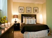Thumbnail 6 of 14 - Bedroom with a queen size bed at Emory Woods Apartments, Durham, NC.