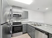 Thumbnail 14 of 23 - A modern kitchen with stainless steel appliances at The Parker North Augusta, North Augusta, SC, 29841