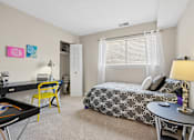 Thumbnail 7 of 51 - Spacious bedroom with desk and natural light at The Palms Apartments, Charleston, South Carolina