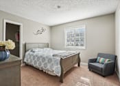 Thumbnail 32 of 36 - Bedroom with a bed and a chair and a window  at Cape Landing, Myrtle Beach, South Carolina