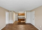 Thumbnail 13 of 17 - A kitchen with white cabinets and a wooden island.
