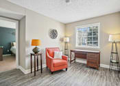 Thumbnail 25 of 36 - Living room with a red chair and a desk  at Cape Landing, Myrtle Beach, SC, 29588