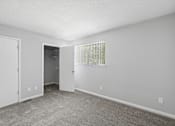 Thumbnail 15 of 24 - A room with a carpeted floor and a window with blinds.