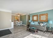 Thumbnail 24 of 36 - Living room and dining room with a couch and a table  at Cape Landing, Myrtle Beach, 29588
