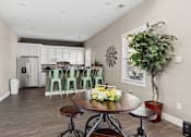 Thumbnail 31 of 39 - Open kitchen with breakfast bar and mint green stools at The Lory of Greenway Village Apartments, Kentucky, 42001
