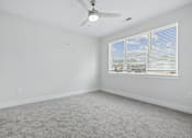 Thumbnail 37 of 51 - Empty bedroom with ceiling fan and window blinds at The Palms Apartments, Charleston, SC 29407