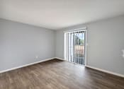 Thumbnail 8 of 15 - Living room with a sliding glass door to a patio  at Governors House, Huntsville, AL, 35805