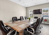 Thumbnail 17 of 39 - Conference room with wood table and executive chairs at The Lory of Greenway Village Apartments, Kentucky, Kentucky