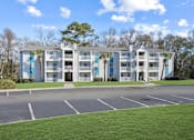 Thumbnail 2 of 36 - Apartment building with a parking lot in front of it  at Cape Landing, Myrtle Beach, 29588