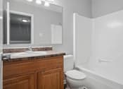 Thumbnail 14 of 24 - A bathroom with a toilet, sink, and bathtub.