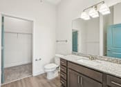 Thumbnail 16 of 28 - A bathroom with a toilet, sink, and mirror.at The Parker Leland, North Carolina, 28451 