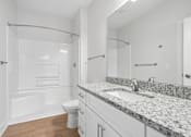 Thumbnail 50 of 51 - Bathroom with granite vanity and tub shower combo at The Palms Apartments, Charleston, SC