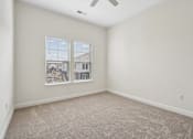 Thumbnail 19 of 28 - A room with a carpet floor and a ceiling fan.at The Parker Leland, North Carolina, 28451 