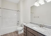Thumbnail 25 of 28 - A white bathroom with a toilet, sink, and shower.at The Parker Leland, North Carolina, 28451 