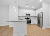 Thumbnail 44 of 51 - Modern kitchen with breakfast bar and granite peninsula at The Palms Apartments, Charleston, South Carolina
