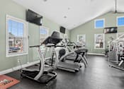 Thumbnail 32 of 39 - Fitness center with cardio machines and tvs at The Lory of Greenway Village Apartments, Kentucky, KY