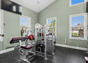 Thumbnail 9 of 39 - A home gym with a weight bench, barbell, and dumbbells. at The Lory of Greenway Village Apartments, Kentucky