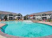 Thumbnail 18 of 39 - A large swimming pool in front of apartment buildings. at The Lory of Greenway Village Apartments, Ky