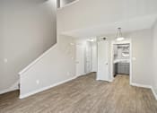 Thumbnail 20 of 26 - the living room and kitchen of a new home with white walls and wood flooring  at Emerald Bay, North Carolina