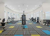 Thumbnail 5 of 28 - A gym with a variety of equipment including treadmills, weights, and exercise machines.at The Parker Leland, Leland, NC 28451  