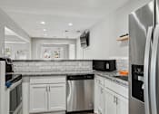 Thumbnail 15 of 26 - Kitchen with stainless steel appliances and granite counter tops at Emerald Bay, Charlotte