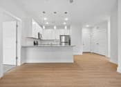 Thumbnail 49 of 51 - Open plan kitchen with breakfast counter and pendant lights at The Palms Apartments, Charleston, South Carolina