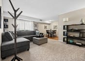 Thumbnail 1 of 51 - Living room with sectional sofa and dining area at The Palms Apartments, South Carolina