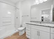 Thumbnail 42 of 51 - Bathroom with white vanity and speckled granite countertop at The Palms Apartments, South Carolina, 29407