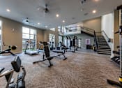 Thumbnail 42 of 47 - spacious gym with cardio machines and weights at The Monroe Apartments, Austin, 78741