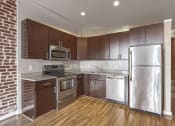 Thumbnail 5 of 50 - a kitchen with stainless steel appliances and wooden cabinets